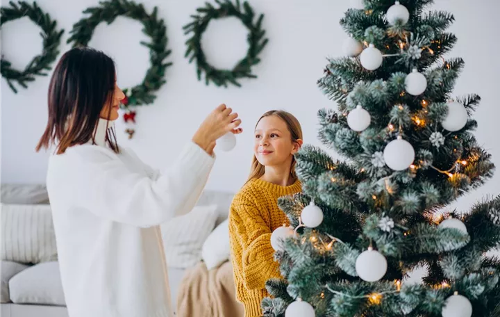 mother-with-daughter-decorating-christmas-tree.jpg