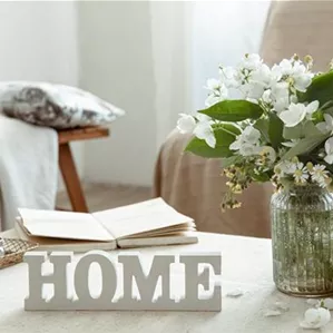 still-life-with-a-bouquet-of-flowers-a-book-and-a-wooden-decorative-word-home.jpg