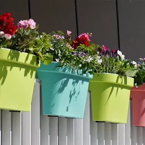 flowers-with-colorful-pots-white-fence.jpg