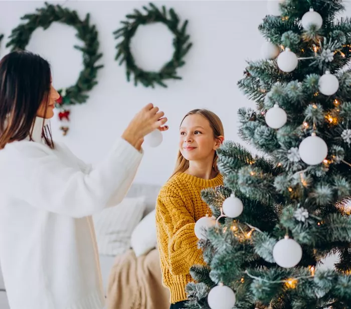 mother-with-daughter-decorating-christmas-tree.jpg